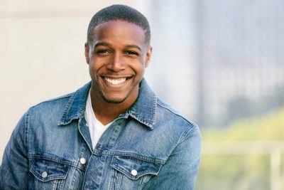 young adult man posing and smiling, happy to live without Tinnitus