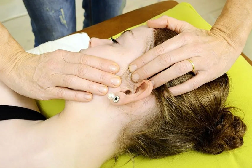 woman having physical therapy on her jaw