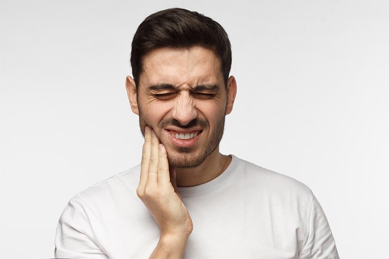 Man with jaw pain possible TMJ symptom